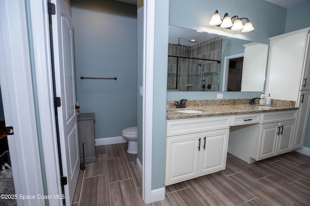 4407 Preservation Cir, Melbourne, FL 32934 - full bath featuring baseboards, a stall shower, wood finish floors, and double vanity