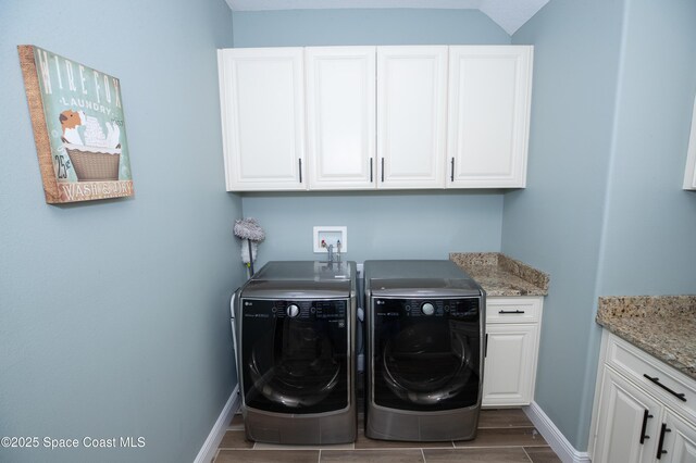 4407 Preservation Cir, Melbourne, FL 32934 - laundry room with cabinet space, washer and clothes dryer, baseboards, and wood finished floors