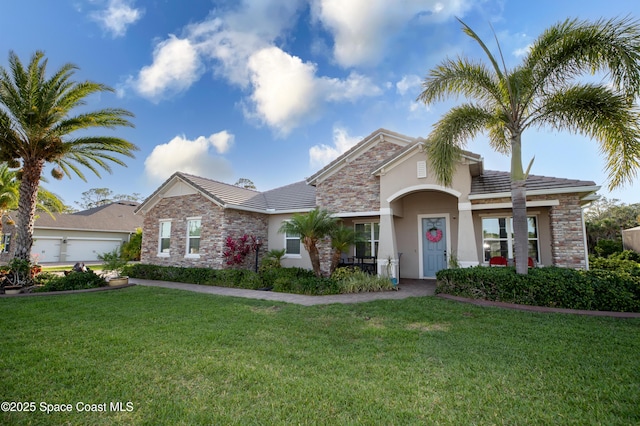 4407 Preservation Cir, Melbourne, FL 32934 - view of front of house featuring stucco siding, a front lawn, stone siding, and a tile roof