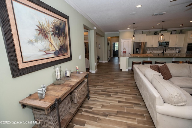 4407 Preservation Cir, Melbourne, FL 32934 - living room with ornamental molding, light wood-style floors, recessed lighting, and baseboards