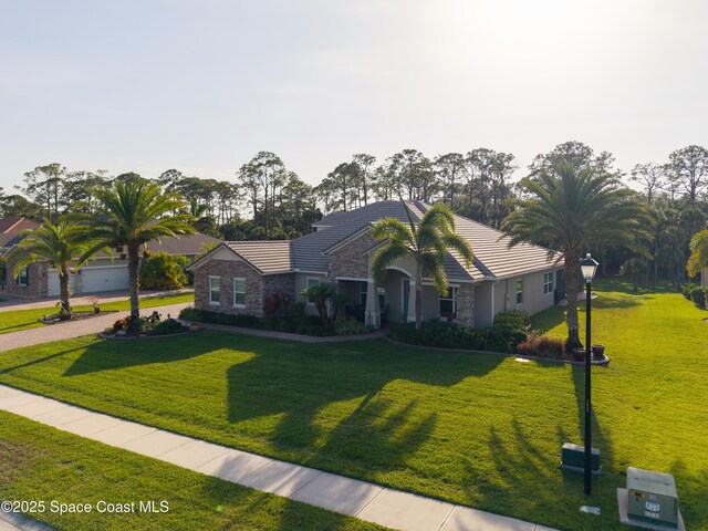 4407 Preservation Cir, Melbourne, FL 32934 - single story home featuring stone siding, a tiled roof, a front lawn, and stucco siding