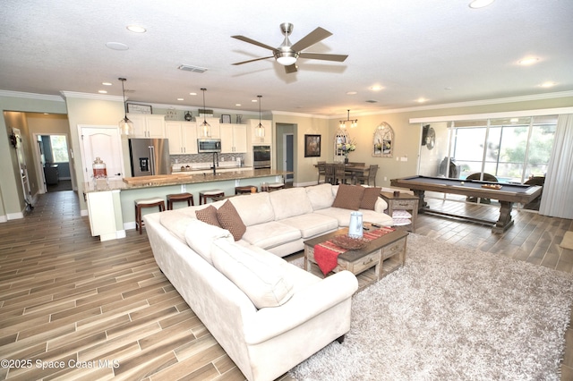 4407 Preservation Cir, Melbourne, FL 32934 - living room with ornamental molding, light wood finished floors, recessed lighting, ceiling fan, and baseboards