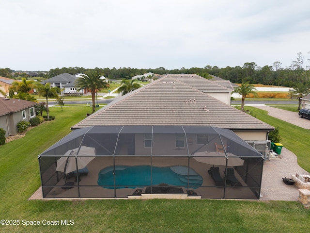 4407 Preservation Cir, Melbourne, FL 32934 - rear view of property featuring a patio, a tile roof, a yard, an outdoor pool, and glass enclosure