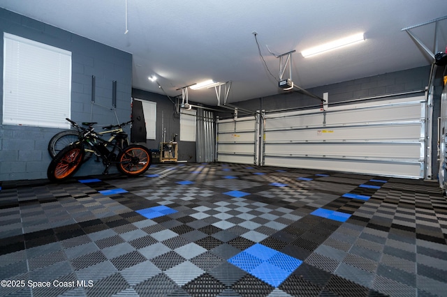 4407 Preservation Cir, Melbourne, FL 32934 - garage featuring a garage door opener and concrete block wall