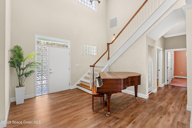 430 Monaco Dr, Indialantic, FL 32903 - foyer with stairway, a high ceiling, light wood-type flooring, and baseboards