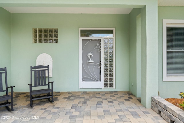 430 Monaco Dr, Indialantic, FL 32903 - doorway to property with stucco siding