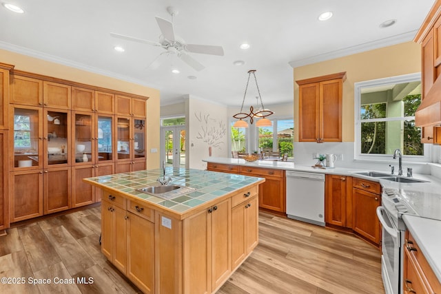 430 Monaco Dr, Indialantic, FL 32903 - kitchen featuring white appliances, tile countertops, a sink, light wood finished floors, and recessed lighting