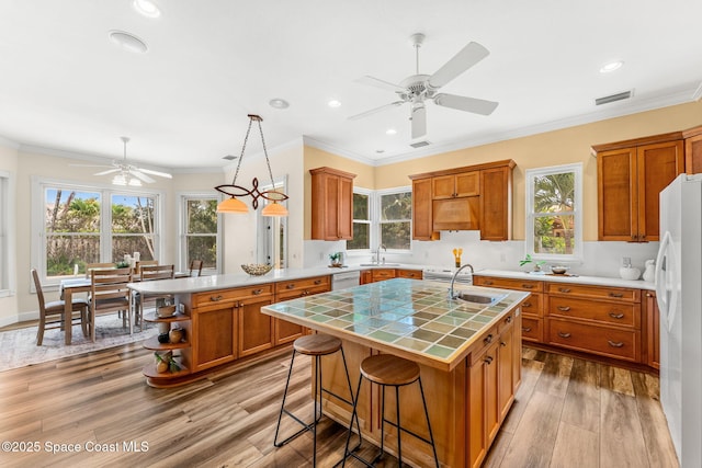 430 Monaco Dr, Indialantic, FL 32903 - kitchen featuring ceiling fan, white appliances, a sink, brown cabinets, and recessed lighting