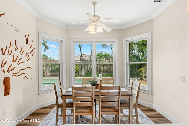430 Monaco Dr, Indialantic, FL 32903 - dining area featuring ceiling fan, dark wood-style flooring, ornamental molding, and baseboards