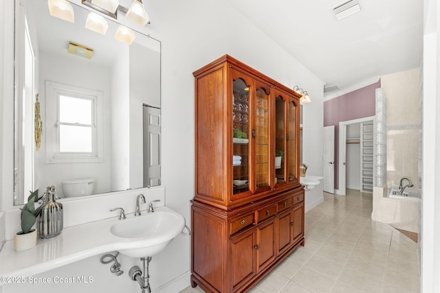 430 Monaco Dr, Indialantic, FL 32903 - full bath with toilet, tile patterned floors, a bathtub, a sink, and baseboards