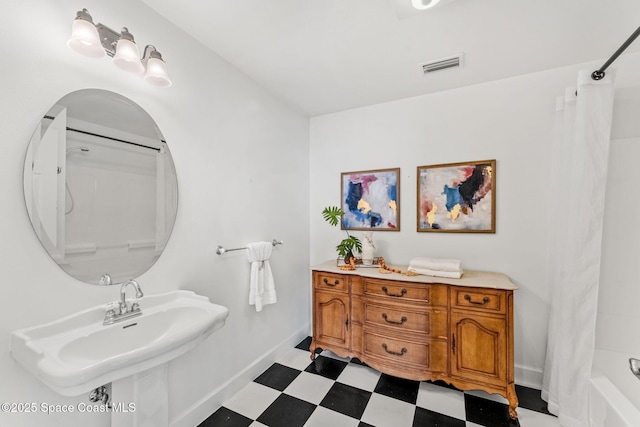 430 Monaco Dr, Indialantic, FL 32903 - full bathroom featuring tile patterned floors, a sink, baseboards, and shower / tub combo