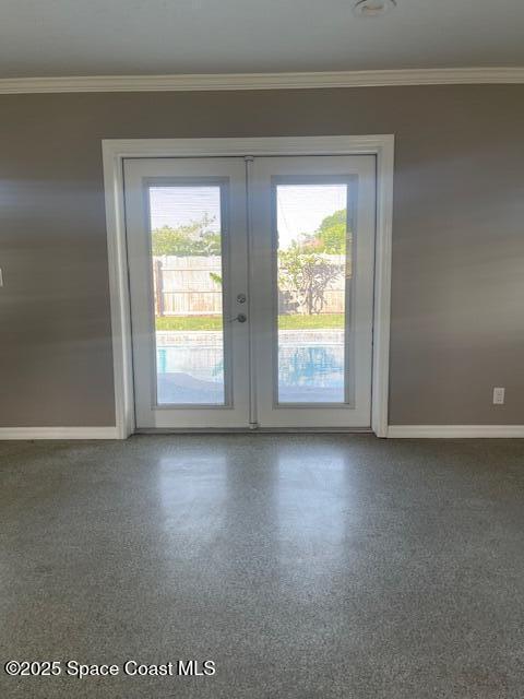 entryway featuring french doors, plenty of natural light, baseboards, and ornamental molding