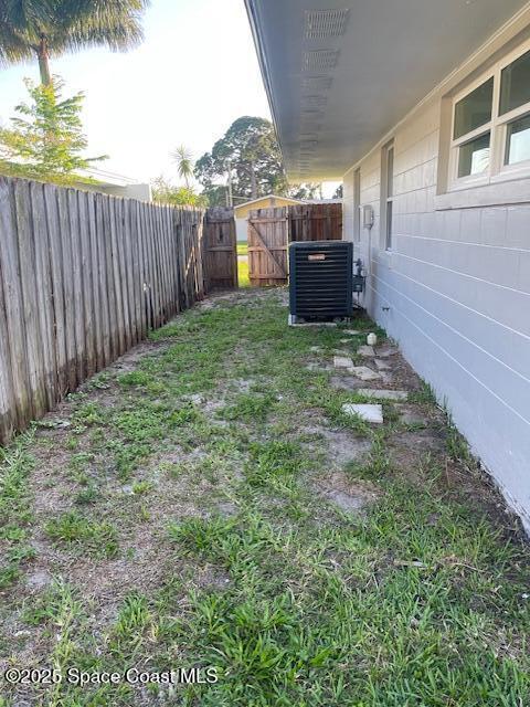 fenced backyard with central AC unit