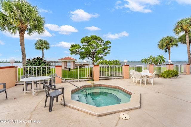 343 N Tropical Trl Unit 404, Merritt Island, FL 32953 - view of swimming pool featuring a community hot tub, fence, a patio area, and outdoor dining area