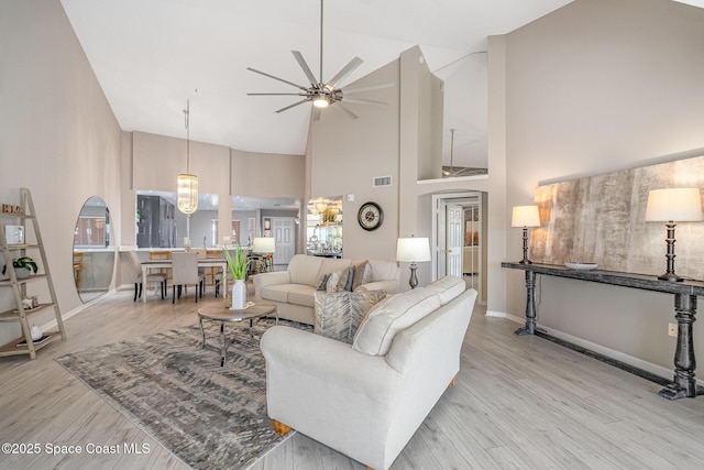343 N Tropical Trl Unit 404, Merritt Island, FL 32953 - living area with high vaulted ceiling, a ceiling fan, wood finished floors, and baseboards