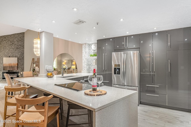 343 N Tropical Trl Unit 404, Merritt Island, FL 32953 - kitchen featuring stainless steel fridge with ice dispenser, a sink, modern cabinets, gray cabinetry, and arched walkways