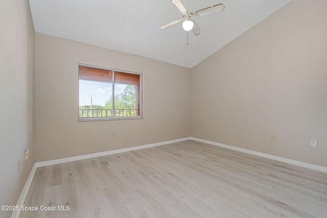 343 N Tropical Trl Unit 404, Merritt Island, FL 32953 - empty room featuring light wood-type flooring, lofted ceiling, ceiling fan, and baseboards