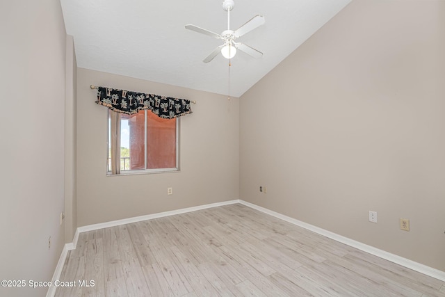 343 N Tropical Trl Unit 404, Merritt Island, FL 32953 - unfurnished room with a ceiling fan, light wood finished floors, vaulted ceiling, and baseboards