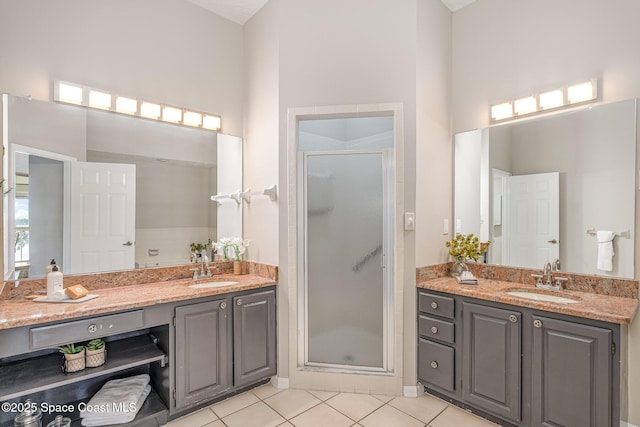 343 N Tropical Trl Unit 404, Merritt Island, FL 32953 - bathroom with a shower stall, tile patterned floors, vanity, and a towering ceiling