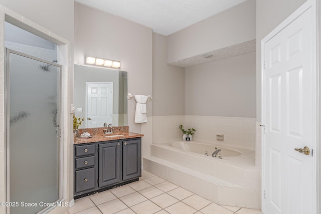 343 N Tropical Trl Unit 404, Merritt Island, FL 32953 - bathroom featuring a shower stall, a bath, tile patterned flooring, and vanity