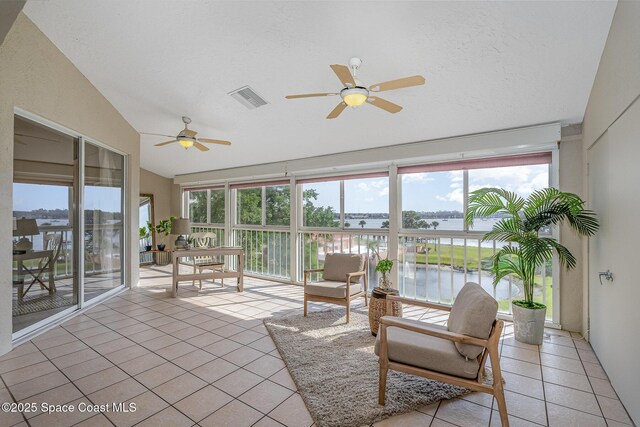 343 N Tropical Trl Unit 404, Merritt Island, FL 32953 - sunroom / solarium featuring lofted ceiling, a water view, tile patterned flooring, and healthy amount of natural light
