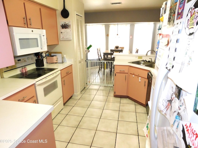 854 Custer St NW, Palm Bay, FL 32907 - kitchen featuring white appliances, a sink, light countertops, and light tile patterned floors