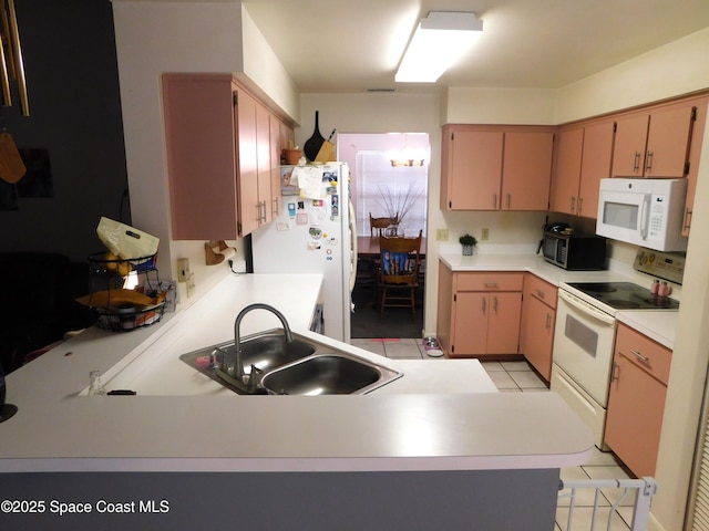 854 Custer St NW, Palm Bay, FL 32907 - kitchen with white appliances, a sink, light tile patterned floors, a peninsula, and light countertops