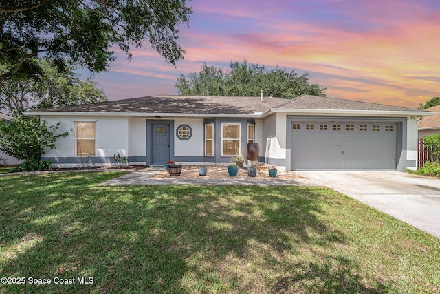2040 Lansing St, Melbourne, FL 32935 - single story home featuring stucco siding, an attached garage, driveway, and a front yard