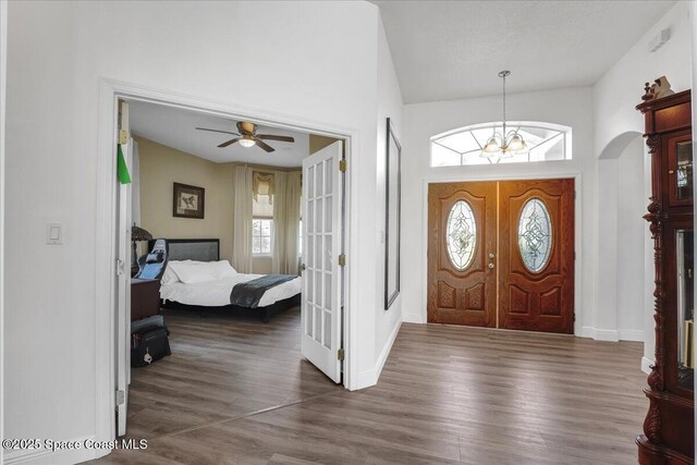 2268 Brightwood Cir, Rockledge, FL 32955 - entrance foyer with wood finished floors, a chandelier, ceiling fan, baseboards, and high vaulted ceiling