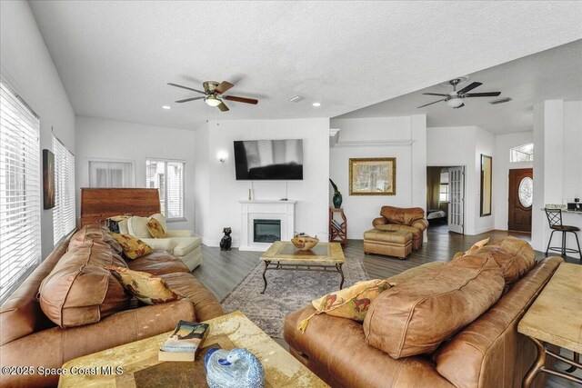 2268 Brightwood Cir, Rockledge, FL 32955 - living room featuring ceiling fan, a glass covered fireplace, wood finished floors, a textured ceiling, and recessed lighting