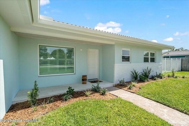 view of front of home featuring brick siding and stucco siding