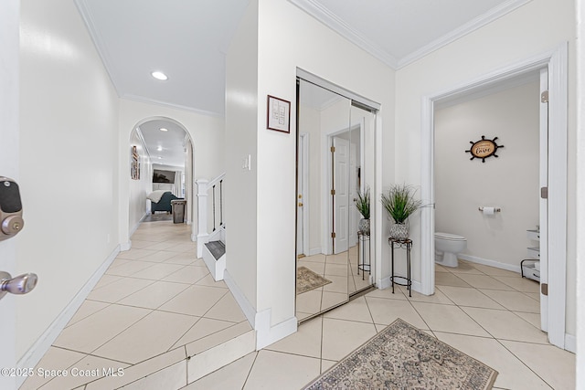 165 Escambia Ln Unit 502, Cocoa Beach, FL 32931 - corridor with arched walkways, crown molding, light tile patterned floors, stairs, and recessed lighting