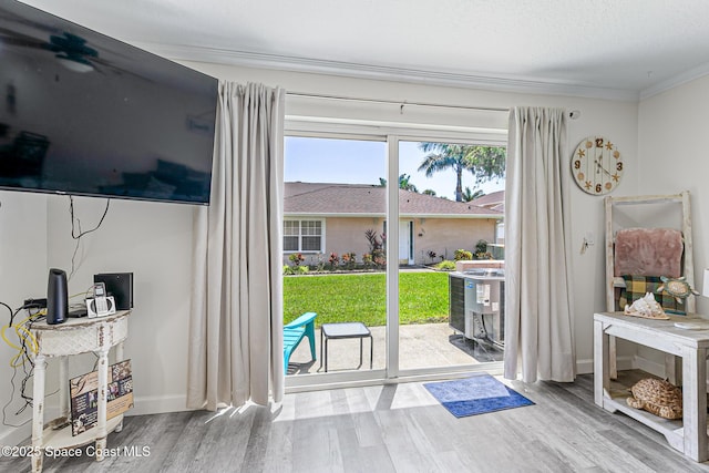 165 Escambia Ln Unit 502, Cocoa Beach, FL 32931 - doorway to outside with wood finished floors, crown molding, and baseboards