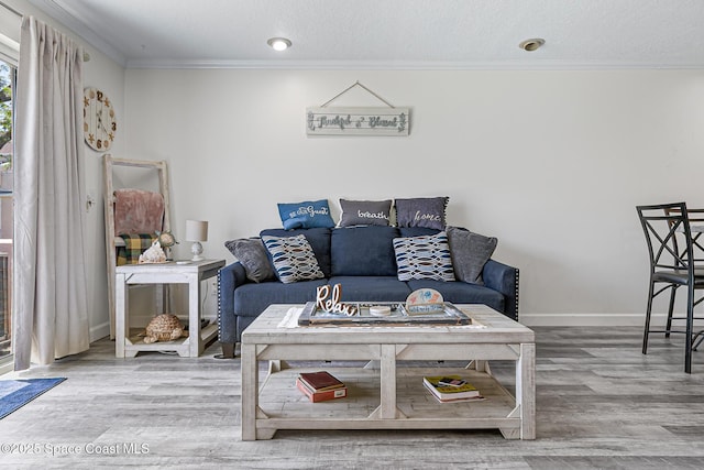 165 Escambia Ln Unit 502, Cocoa Beach, FL 32931 - living area featuring crown molding, wood finished floors, and baseboards
