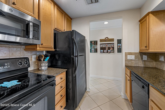 165 Escambia Ln Unit 502, Cocoa Beach, FL 32931 - kitchen featuring black appliances, light tile patterned flooring, baseboards, dark stone counters, and decorative backsplash