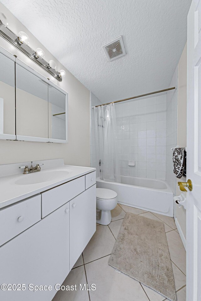 165 Escambia Ln Unit 502, Cocoa Beach, FL 32931 - full bathroom with shower / tub combo with curtain, toilet, tile patterned floors, a textured ceiling, and vanity
