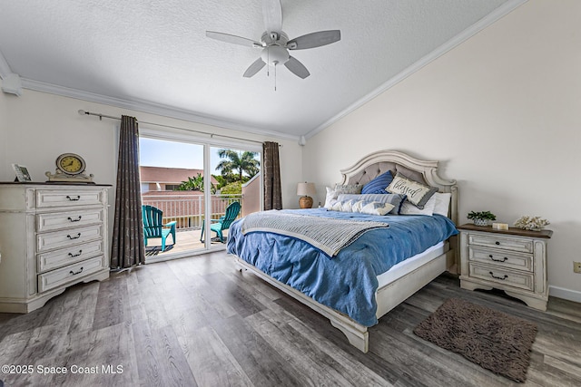 165 Escambia Ln Unit 502, Cocoa Beach, FL 32931 - bedroom featuring access to outside, vaulted ceiling, wood finished floors, crown molding, and a textured ceiling