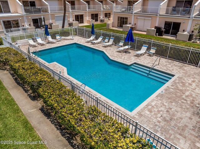165 Escambia Ln Unit 502, Cocoa Beach, FL 32931 - community pool with fence and a patio area