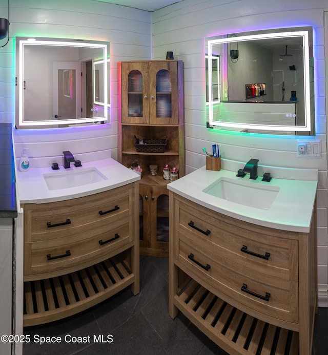 886 Spirea Dr, Rockledge, FL 32955 - full bathroom featuring two vanities and wood walls