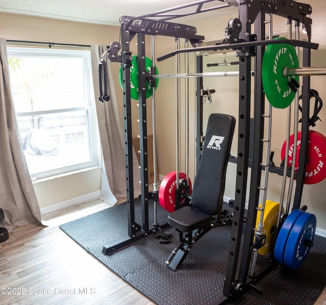 886 Spirea Dr, Rockledge, FL 32955 - exercise room with wood finished floors and baseboards