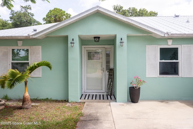 886 Spirea Dr, Rockledge, FL 32955 - property entrance with stucco siding and metal roof