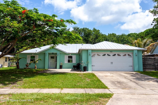 886 Spirea Dr, Rockledge, FL 32955 - ranch-style house featuring stucco siding, metal roof, driveway, and a garage