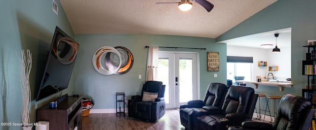 886 Spirea Dr, Rockledge, FL 32955 - living room with wood finished floors, ceiling fan, lofted ceiling, french doors, and a textured ceiling