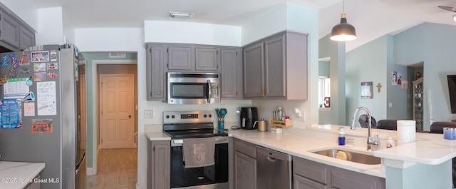 886 Spirea Dr, Rockledge, FL 32955 - kitchen featuring stainless steel appliances, a sink, gray cabinets, light countertops, and a peninsula