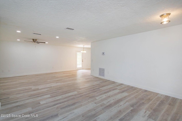 129 Irvine Ave SE, Palm Bay, FL 32909 - spare room featuring light wood-type flooring, a chandelier, recessed lighting, baseboards, and a textured ceiling