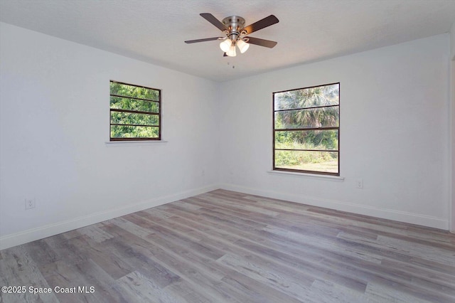 129 Irvine Ave SE, Palm Bay, FL 32909 - spare room featuring a ceiling fan, light wood-style flooring, and baseboards