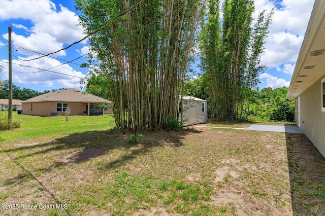 129 Irvine Ave SE, Palm Bay, FL 32909 - view of green lawn with an outbuilding and a shed