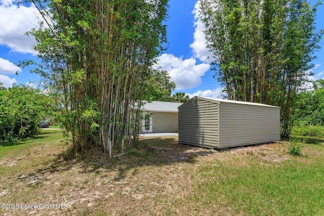 129 Irvine Ave SE, Palm Bay, FL 32909 - view of yard featuring an outdoor structure and a shed