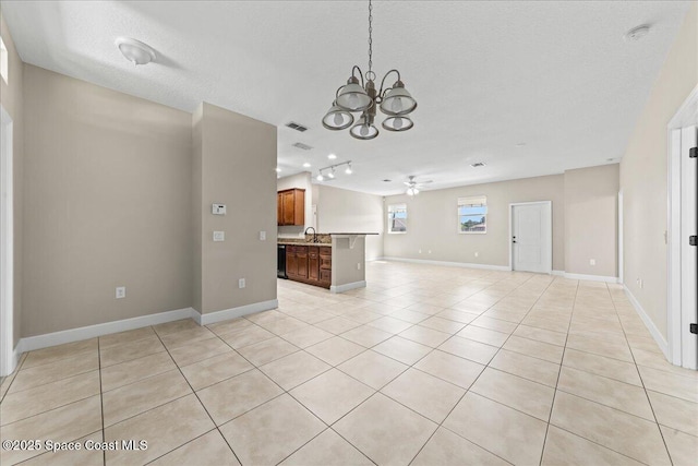 unfurnished living room with a chandelier, light tile patterned floors, ceiling fan, a textured ceiling, and baseboards