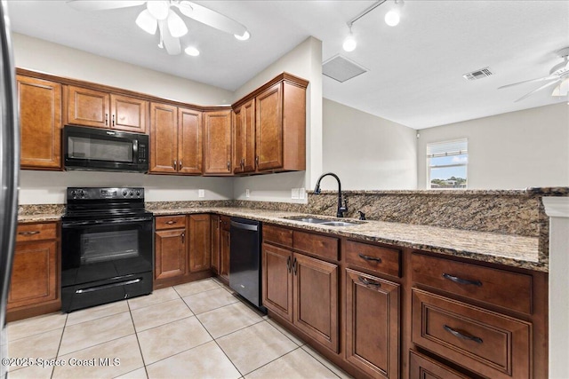 kitchen with black appliances, ceiling fan, a sink, stone countertops, and light tile patterned floors